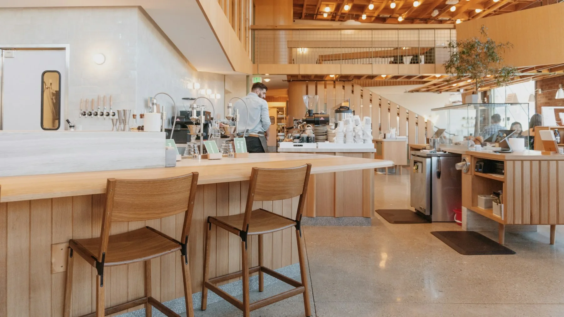 The long counter and wooden seating inside Verve Coffee Roasters in the Arts District
